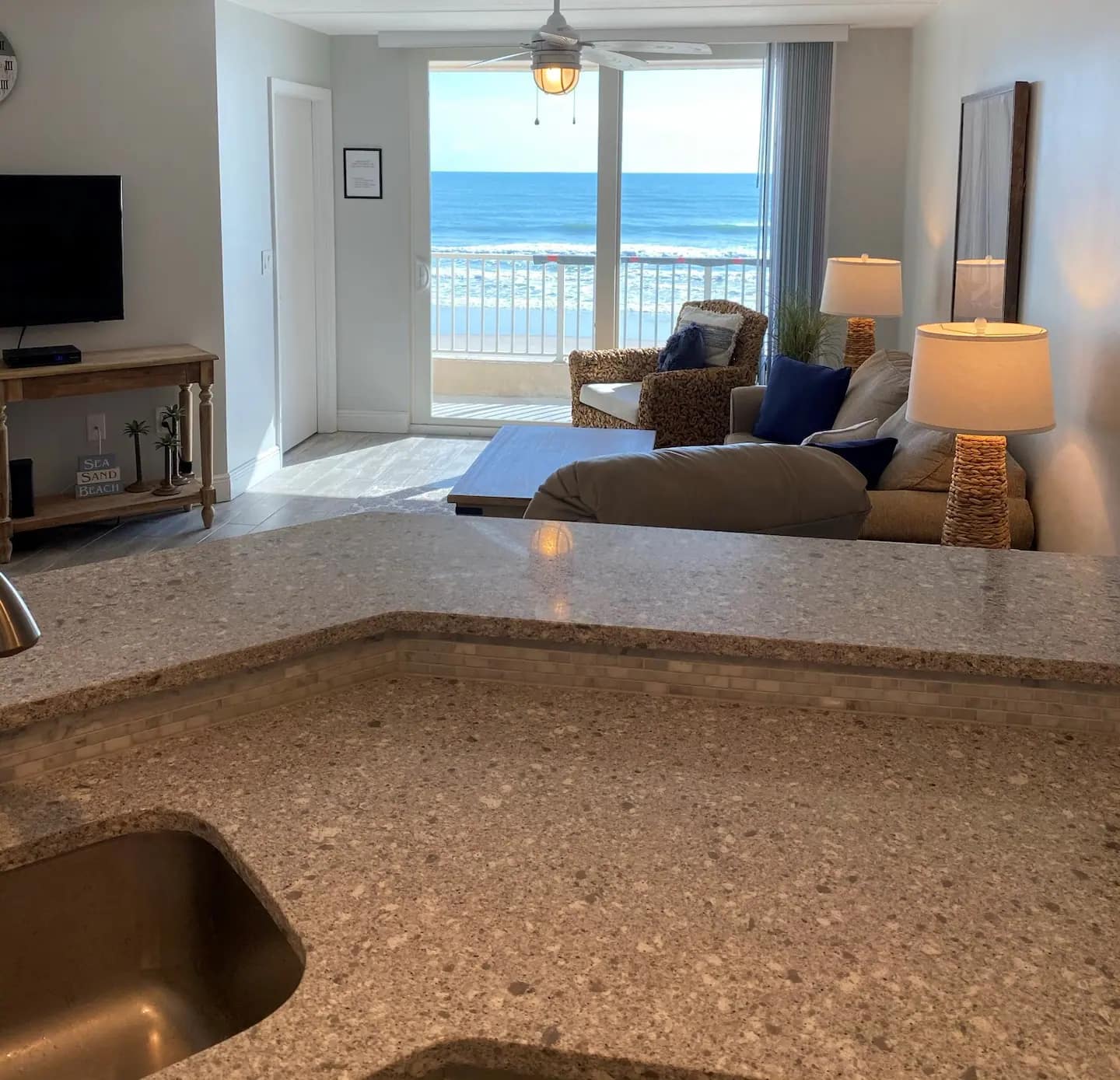 Ocean view through the living-room balcony slider at Beachside Bliss